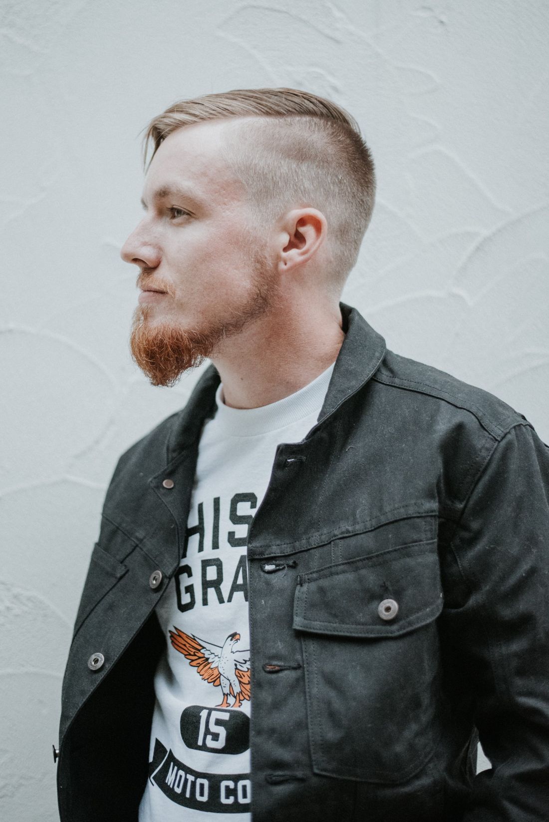 Josh Witt in profile against a white wall